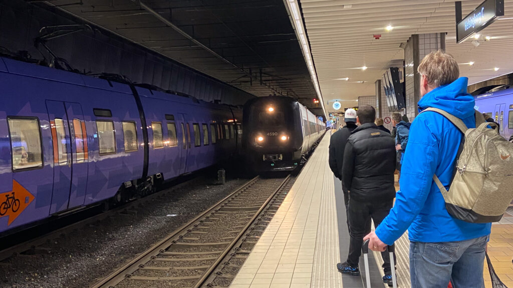 Tågstation, folk väntar på tåget